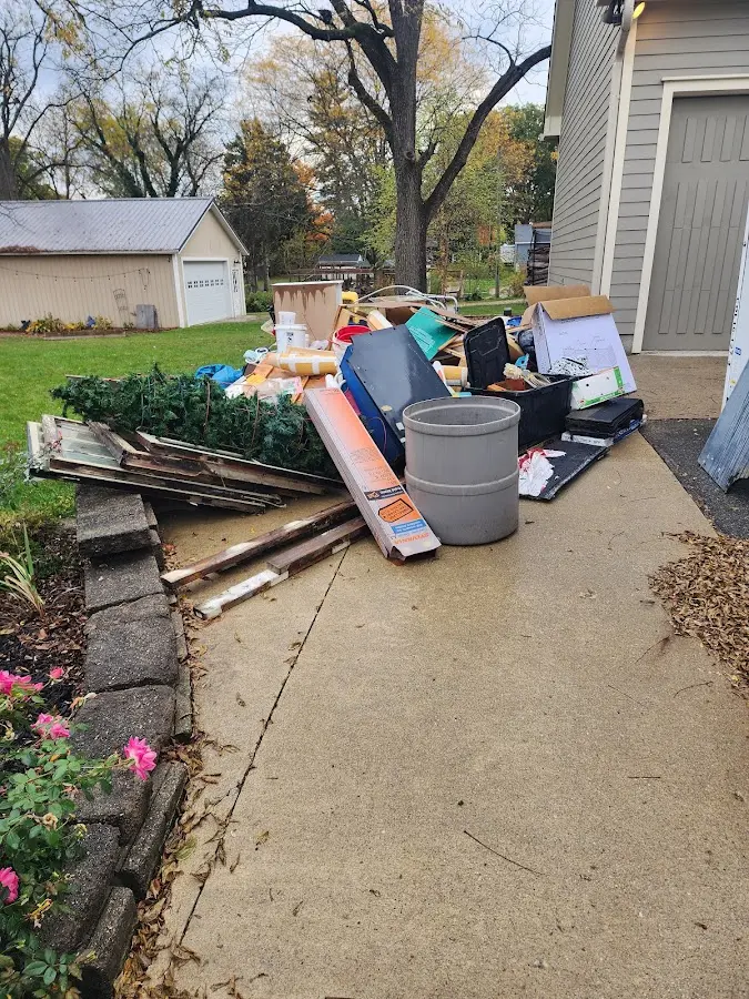 Dumpster being loaded with debris for Estate Cleanout Dumpster Rental in Cuero